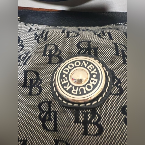 Dooney & Burke black logo printed fabric with black pebbled leather accents. - Picture 5 of 9